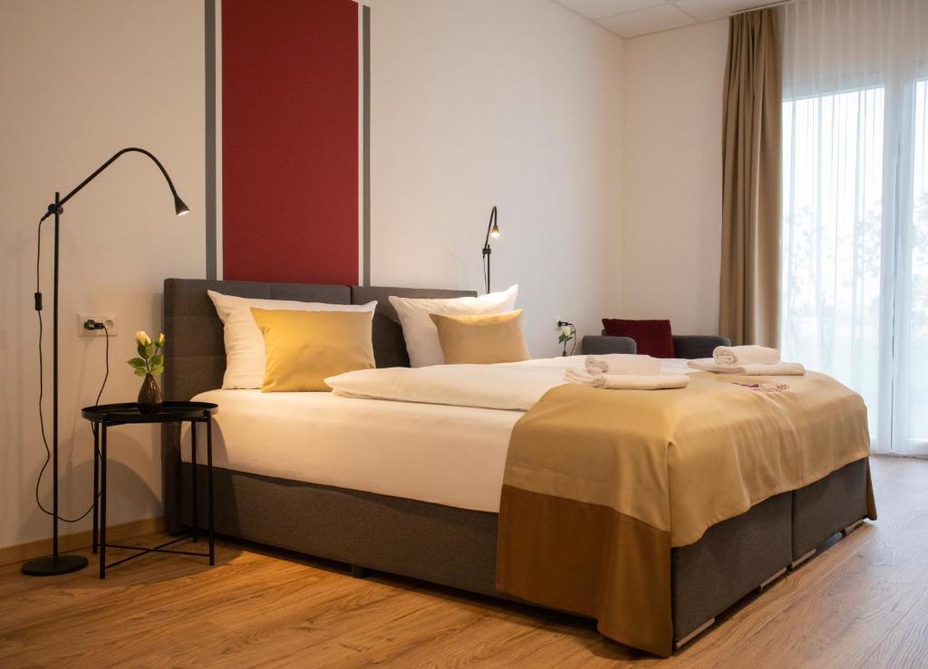 1 dormitorio con 1 cama grande con almohadas amarillas en B Home Apart Hotel by Alpha, en Bogen