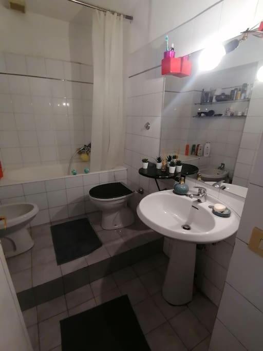 biała łazienka z umywalką i toaletą w obiekcie La Tua Casa A Trastevere w Rzymie