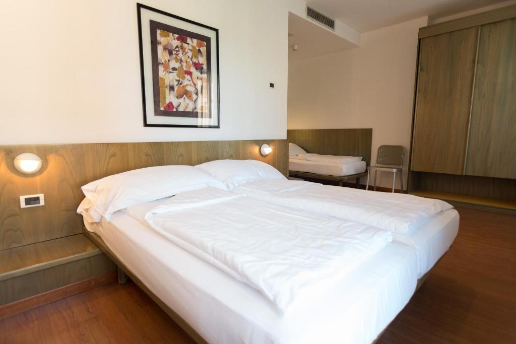Postel nebo postele na pokoji v ubytování Hotel Al Caval