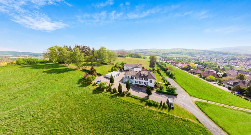 an aerial view of a large house on a green field at Hotel Görtler in Seesen