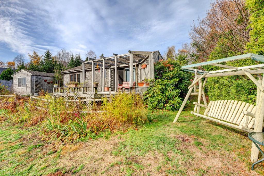 a house sitting on the side of a hill at Serene Jonesport Escape Deck with Water Views! in Jonesport