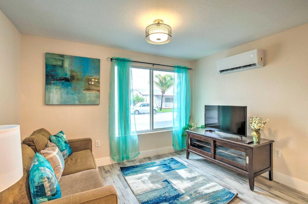 a living room with a couch and a tv at Turquoise Escape about 1 Mi to Sailfish Marina! in West Palm Beach