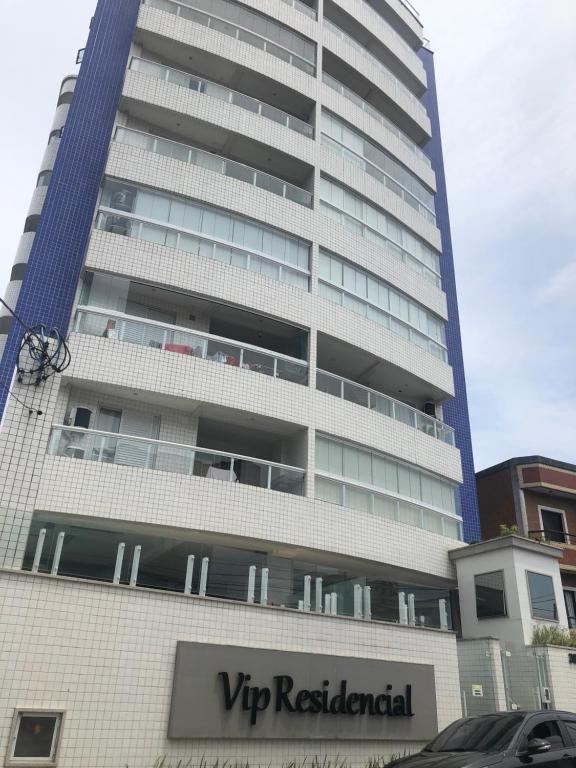 Um edifício alto com um sinal de aluguer VIP à frente. em Vip Residencial - Praia Grande na Praia Grande