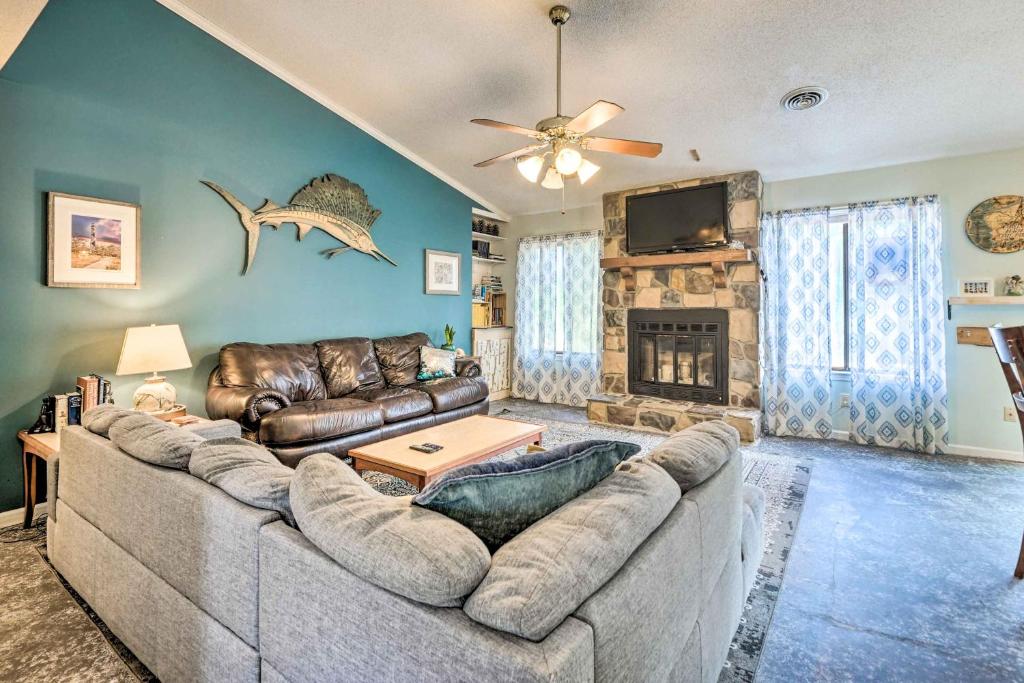 a living room with a couch and a fireplace at Pet-Friendly Wilmington Home with Fenced Yard! in Wilmington
