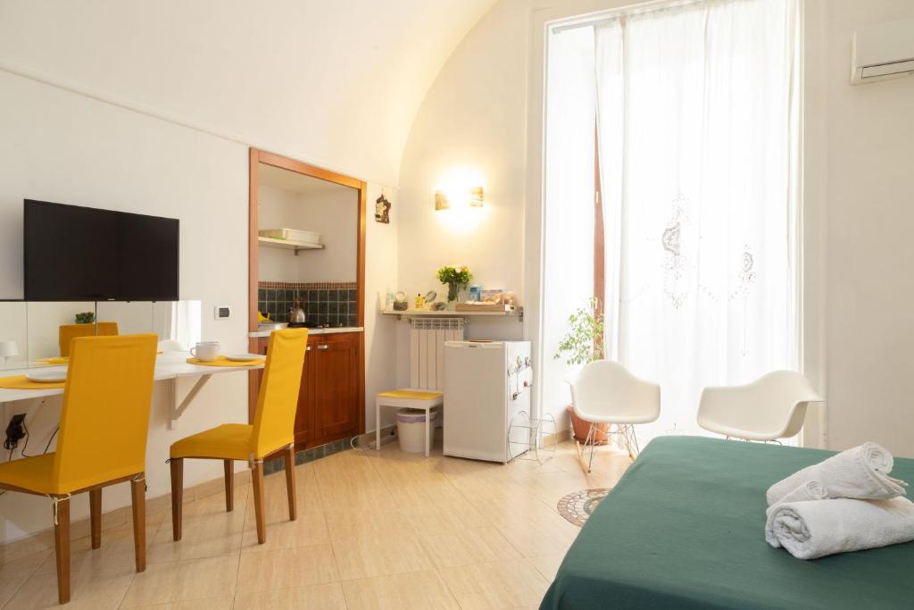 sypialnia z łóżkiem, stołem i krzesłami w obiekcie Neapolitan Style Apartrment w mieście Neapol