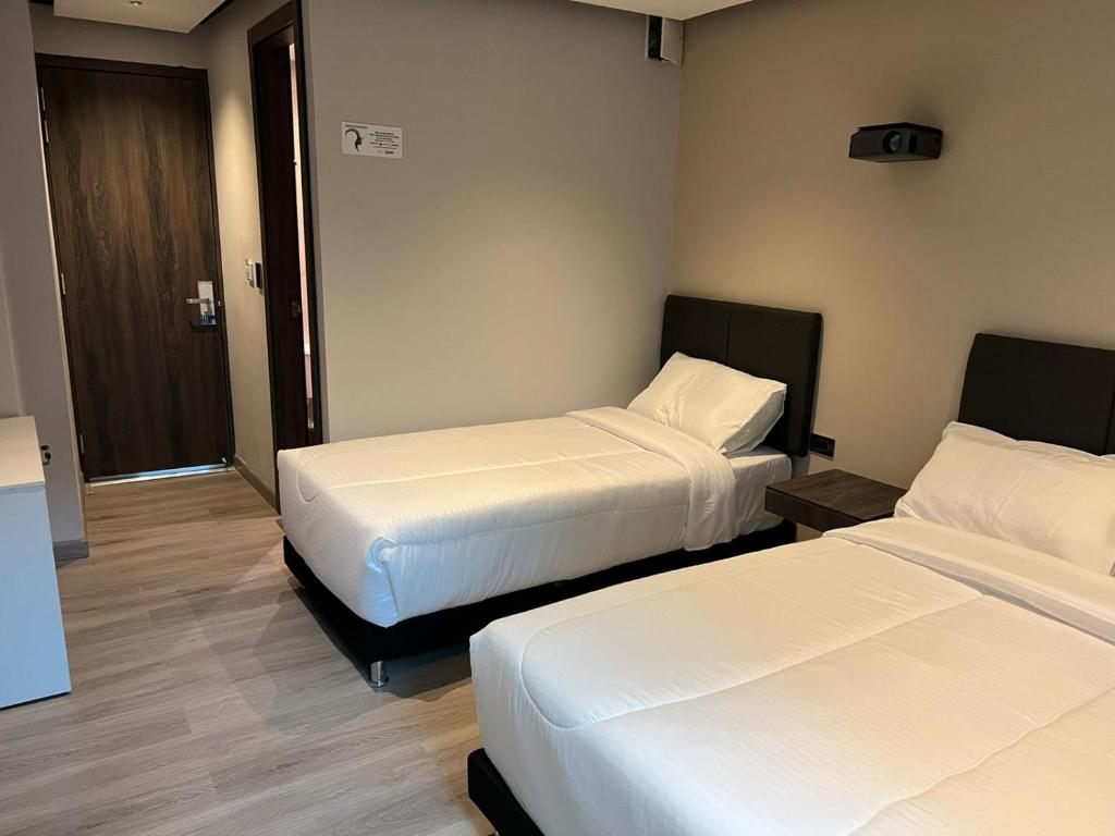 Postel nebo postele na pokoji v ubytování HOTEL HTL