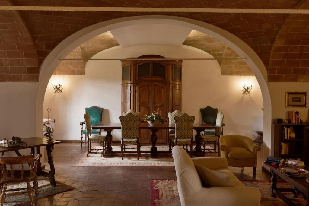 a living room with a table and chairs at Timeless Elegance in Poggibonsi