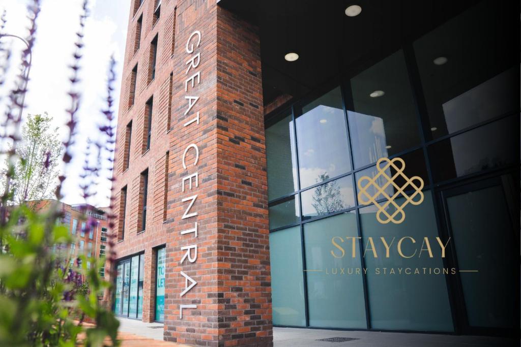 a brick building with a sign on the side of it at Modern 1-Bed Apartments - New - City Centre - FREE Wi-Fi - in Sheffield