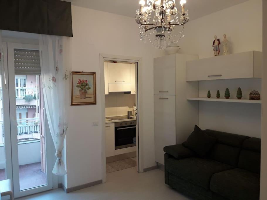 sala de estar con sofá y cocina en Appartamento vittoria, en Pietra Ligure
