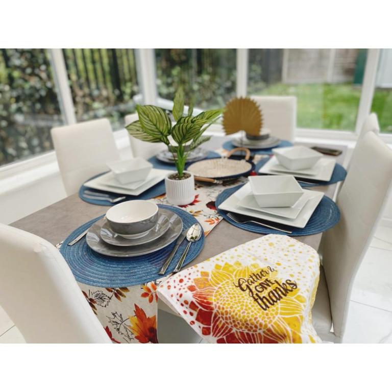 a dining room table with plates and dishes on it at Cosy & Spacious Lodge Dartford in Kent