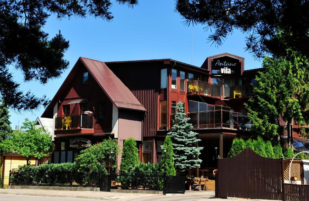 a building with a sign on the side of it at Antano Vila in Palanga