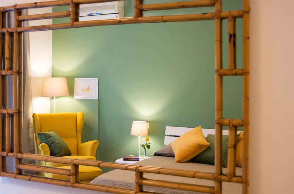a room with a bunk bed and a yellow chair at Portobello Apartments in Bologna