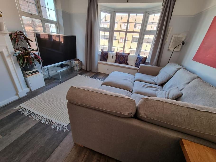 a living room with a couch and a flat screen tv at Lovely 2 bedroom flat in North West London in Hendon