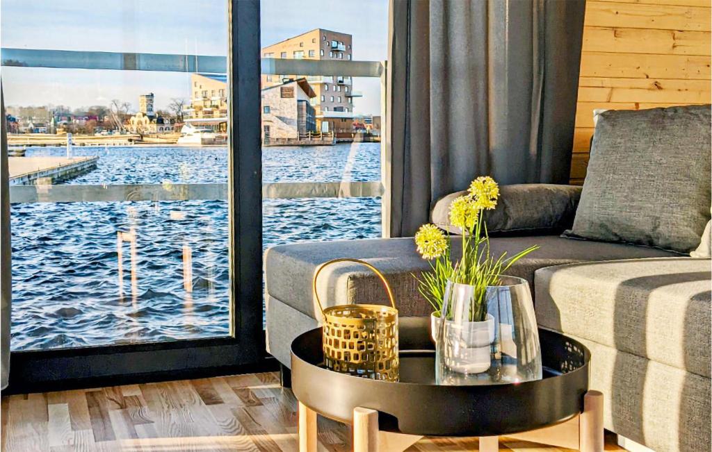 a living room with a couch and a view of the water at Gorgeous Ship In Vstervik With Wifi in Västervik