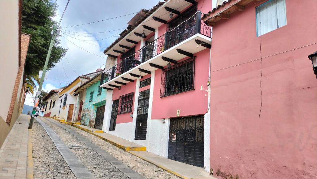 a row of colorful buildings on a street at kukulkan hostal in San Cristóbal de Las Casas
