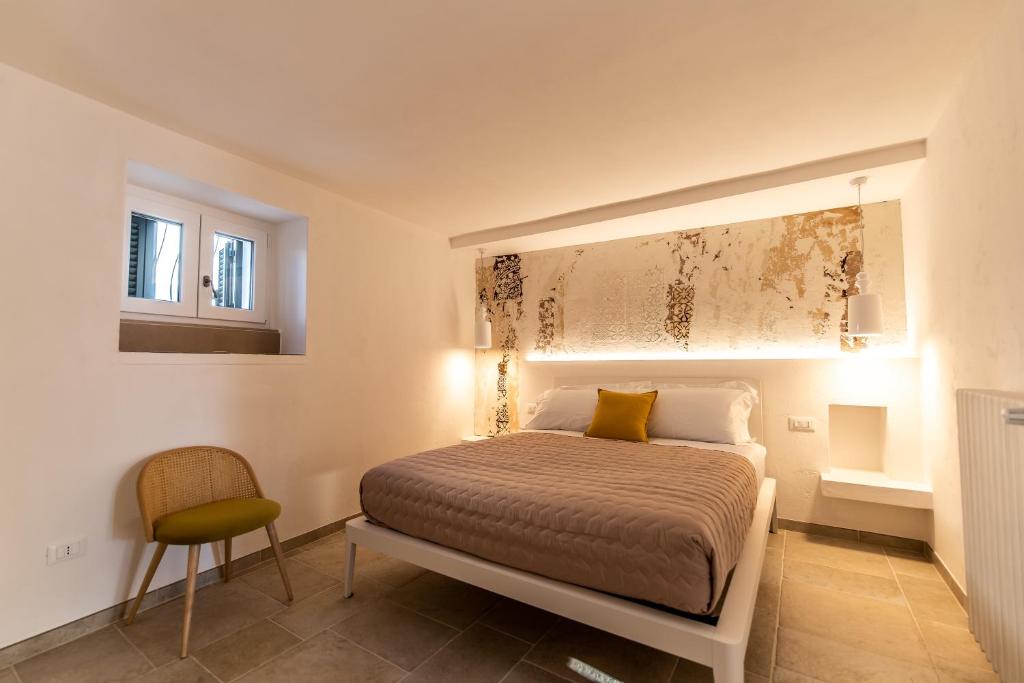 En eller flere senge i et værelse på DIMORA PALASCIANO