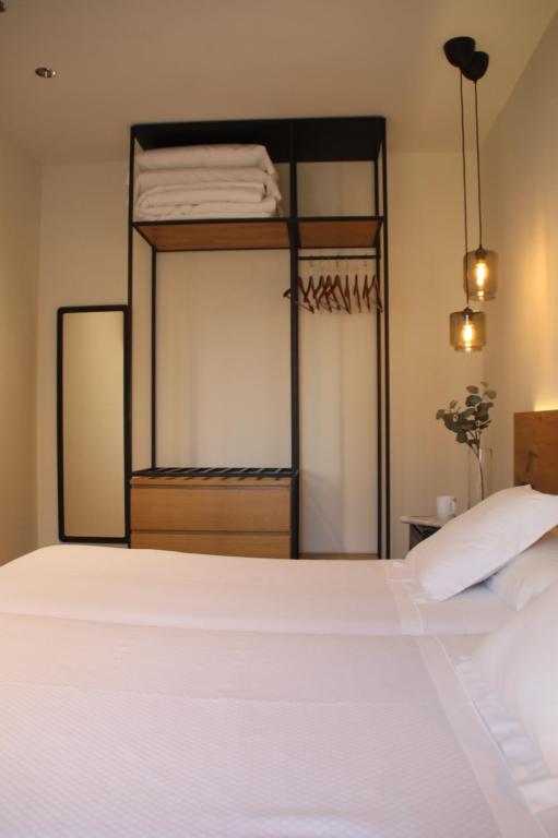 A bed or beds in a room at Hotel Boutique Astorga