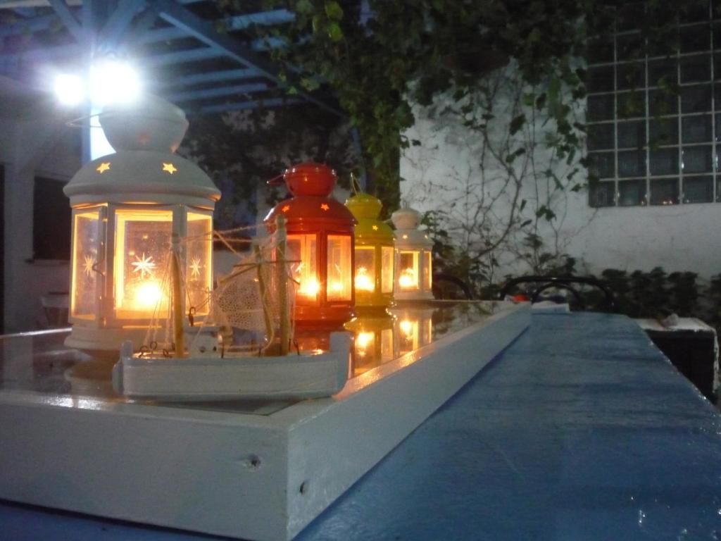 a group of lanterns sitting on a table at night at Apanemia Rooms in Kini