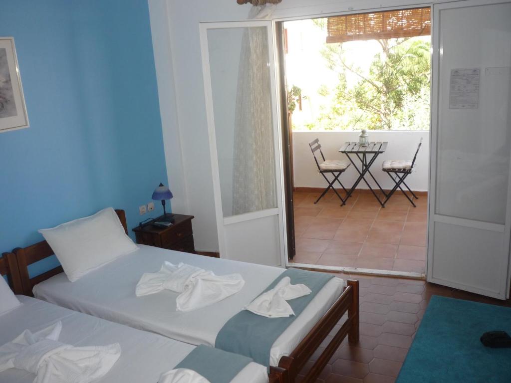 Postel nebo postele na pokoji v ubytování Apanemia Rooms