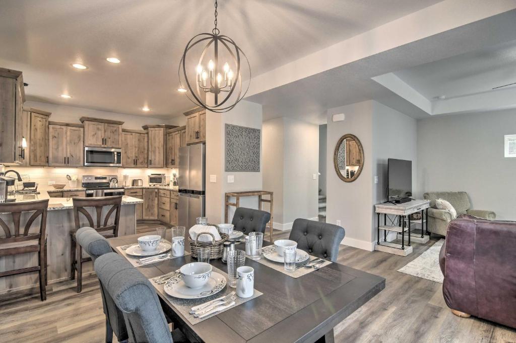 a dining room and kitchen with a table and chairs at Gorgeous Loveland Townhome Less Than 1 Mi to Downtown in Loveland