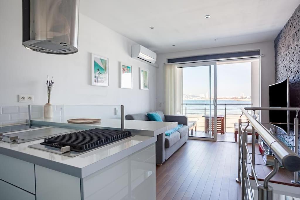 a kitchen with a stove and a living room at Cabanon avec terrasse - bord de plage - Le Cabanon 12 in Marseille