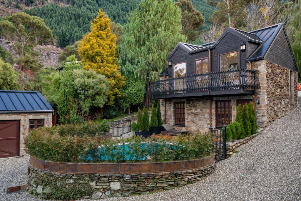 a house with a garden in front of it at Alpine Cottage in Queenstown