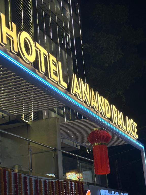 a neon sign for a hotelanimal franchise on a building at Hotel Anand Palace in Shirdi