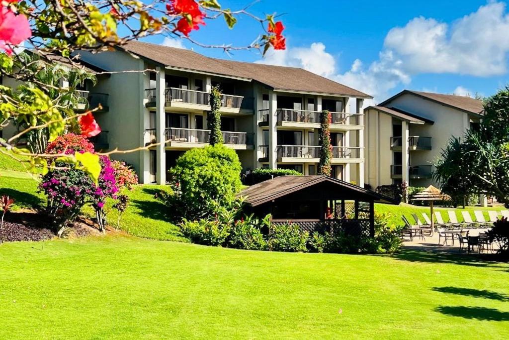a large apartment building with a lawn in front of it at Hanalei Bay Resort 6222 in Princeville