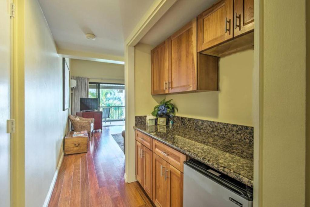 a kitchen with wooden cabinets and a counter top at Hanalei Bay Resort 2302 in Princeville