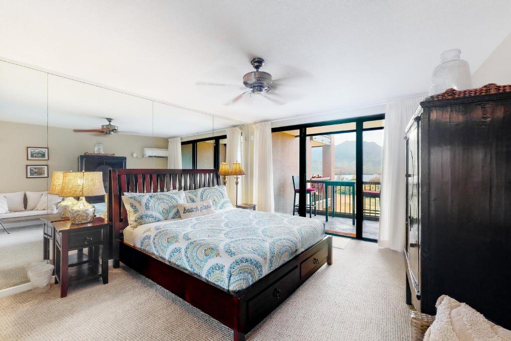 a bedroom with a bed and a balcony at Hanalei Bay Resort 9204 in Princeville