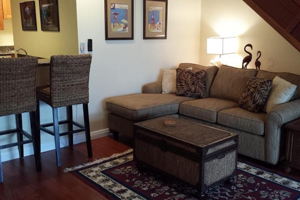 a living room with a couch and a table at Hanalei Bay Resort 2301 in Princeville