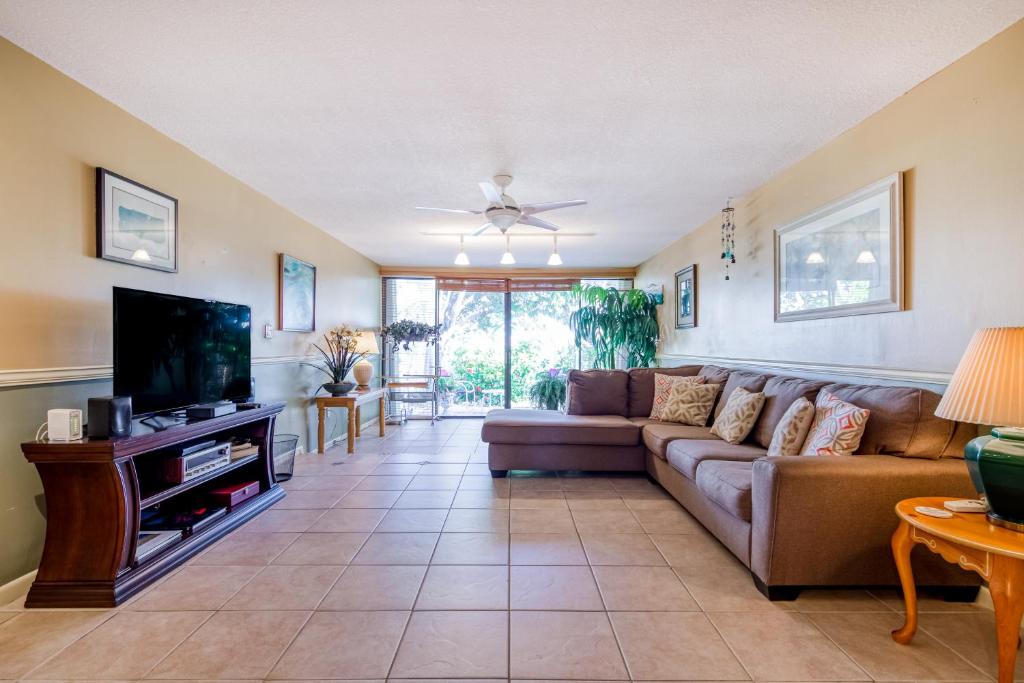 a living room with a couch and a flat screen tv at Escape to the Keys in Islamorada