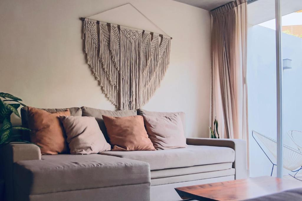 a living room with a couch and a window at Casa Azul 2 BedBath in Tulum