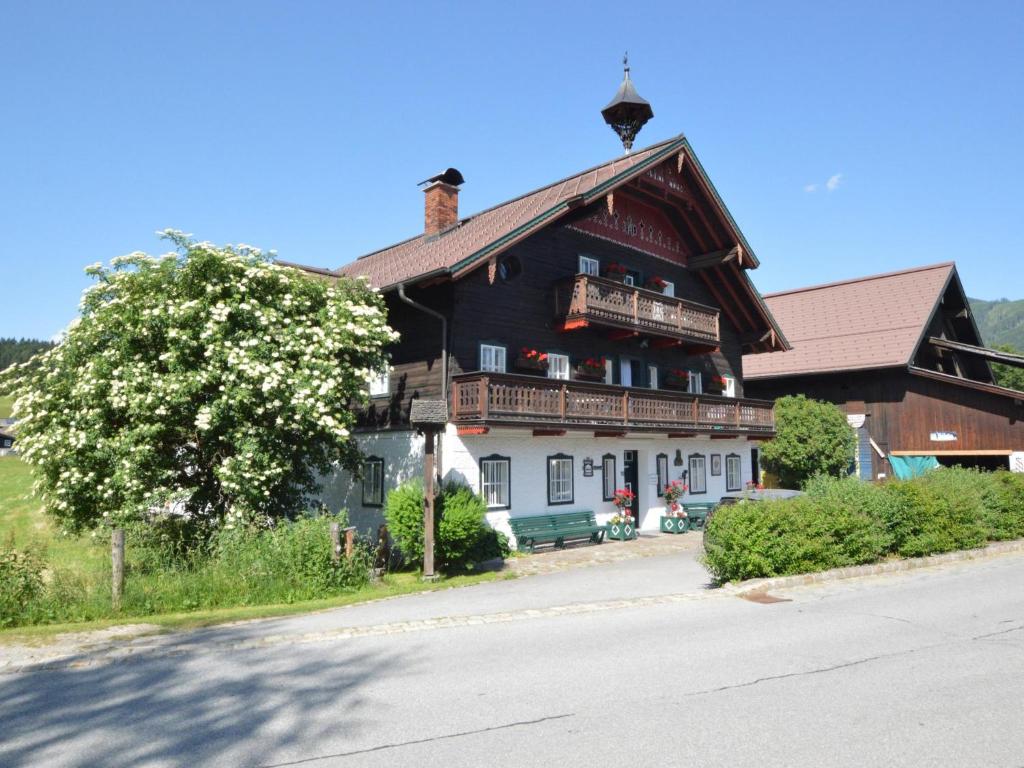 a large wooden house with a tree in front of it at Illusion in Flachau
