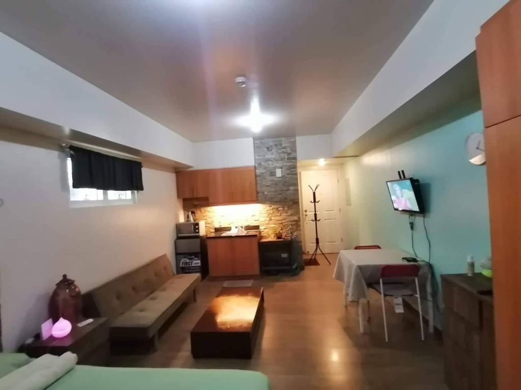 a living room with a couch and a table at Celadon Tower- Studio with balcony near SM San Lazaro in Manila