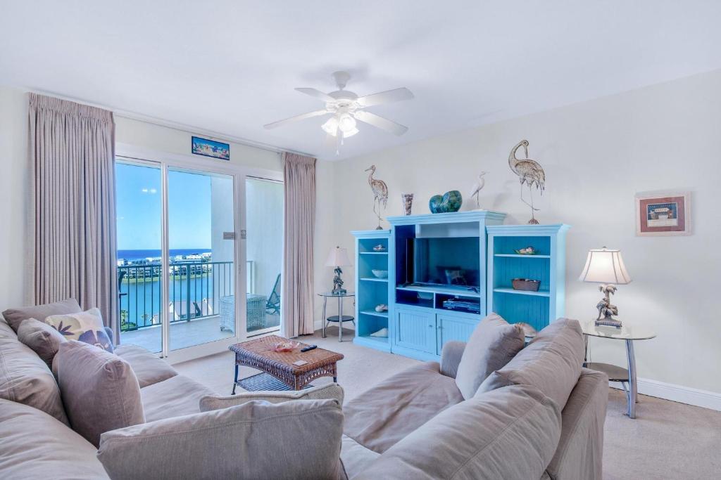 a living room with a couch and a blue cabinet at Ariel Dunes II 1003 in Destin