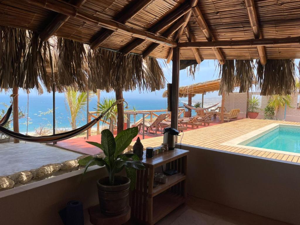 a view of a resort with a swimming pool at Casa Vistamar y Bungalows in Los Órganos