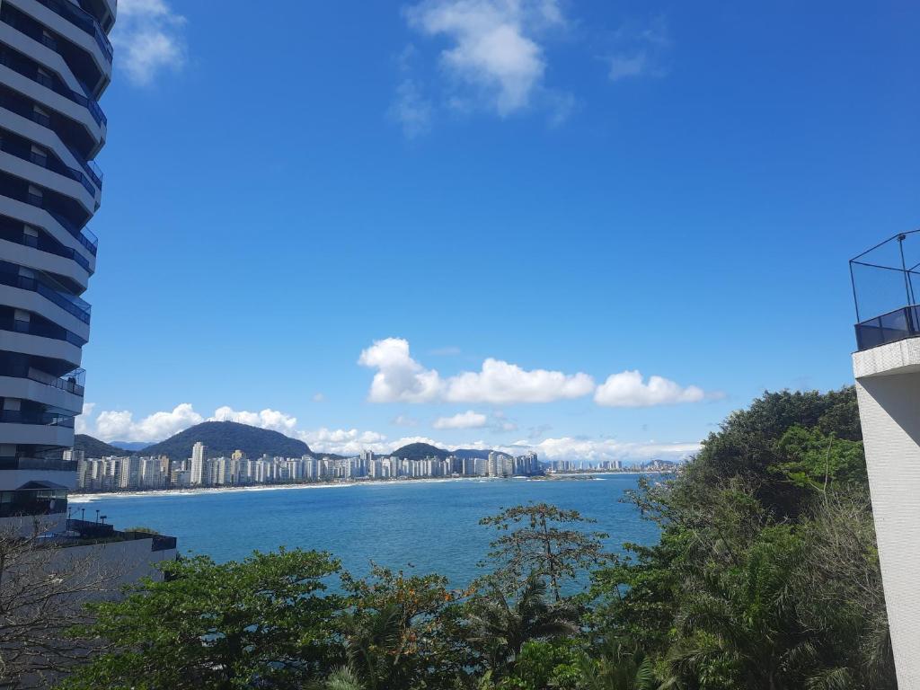 a view of a large body of water with buildings at Guaruja Apartment in Guarujá