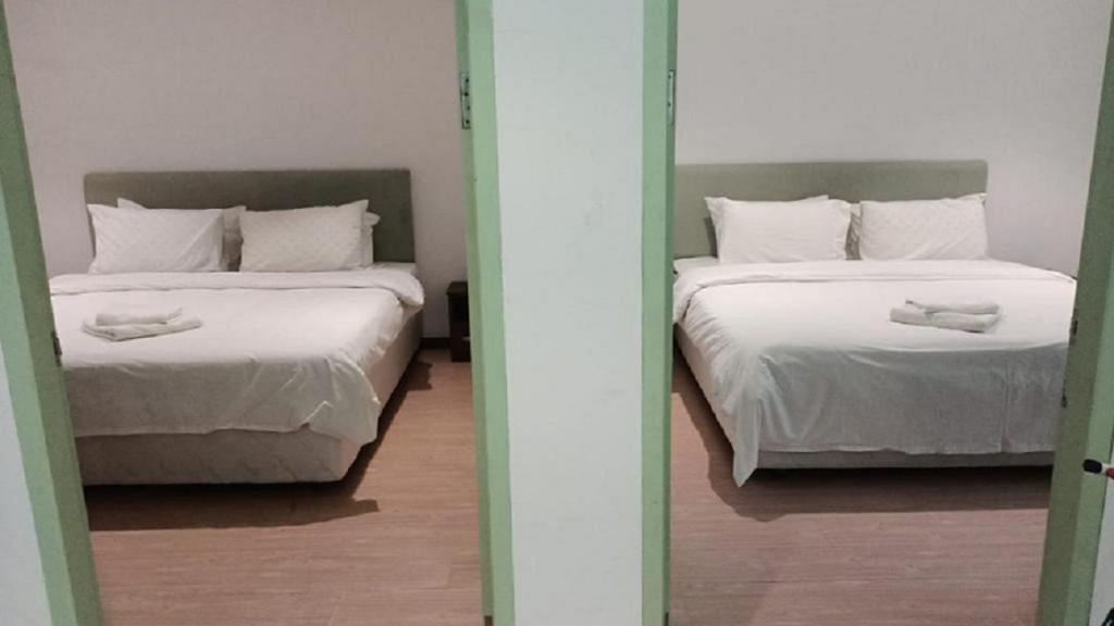 Postel nebo postele na pokoji v ubytování MCITI Suites
