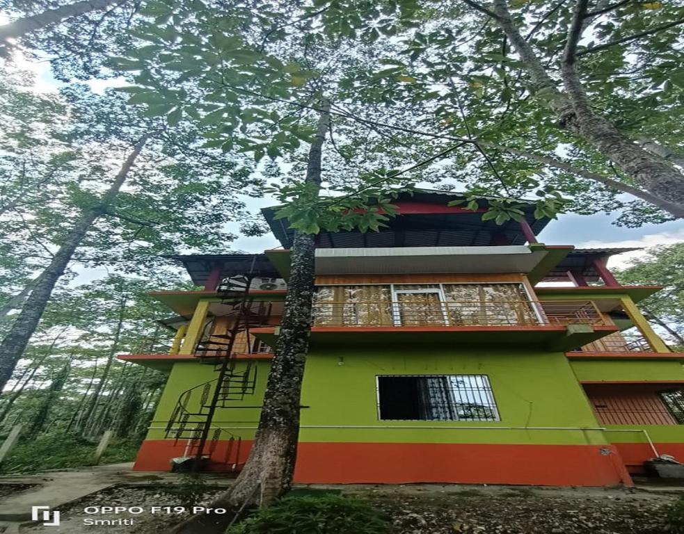 a house in the middle of a forest at Jaldapara Riverhine by StayApart in Uttar Simlabari