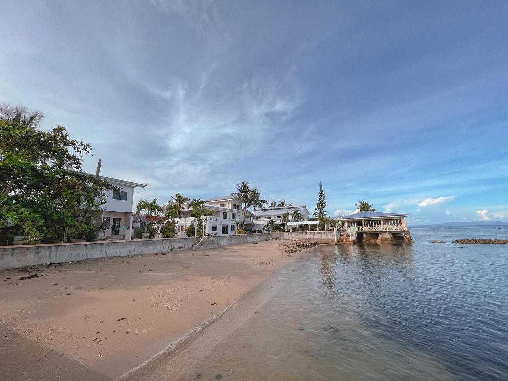 a view of a beach with houses and the water at Ocean Bay Beach Resort in Dalaguete