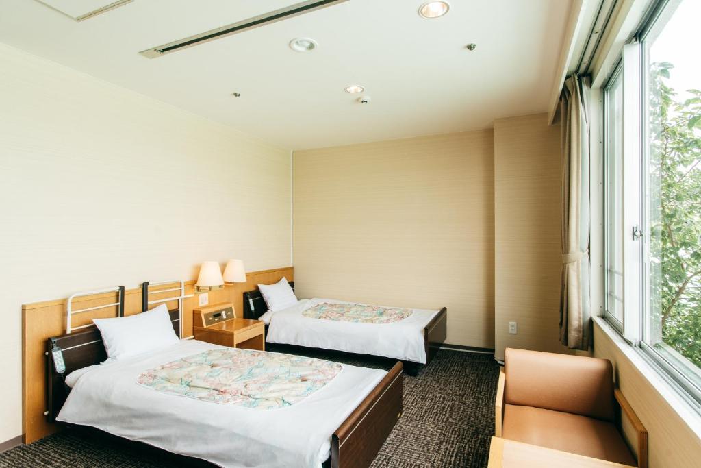 Postel nebo postele na pokoji v ubytování KAMENOI HOTEL Yanagawa