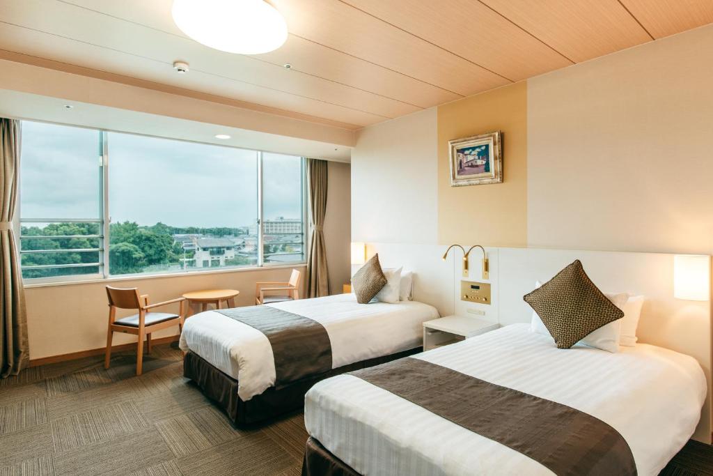Postel nebo postele na pokoji v ubytování KAMENOI HOTEL Yanagawa