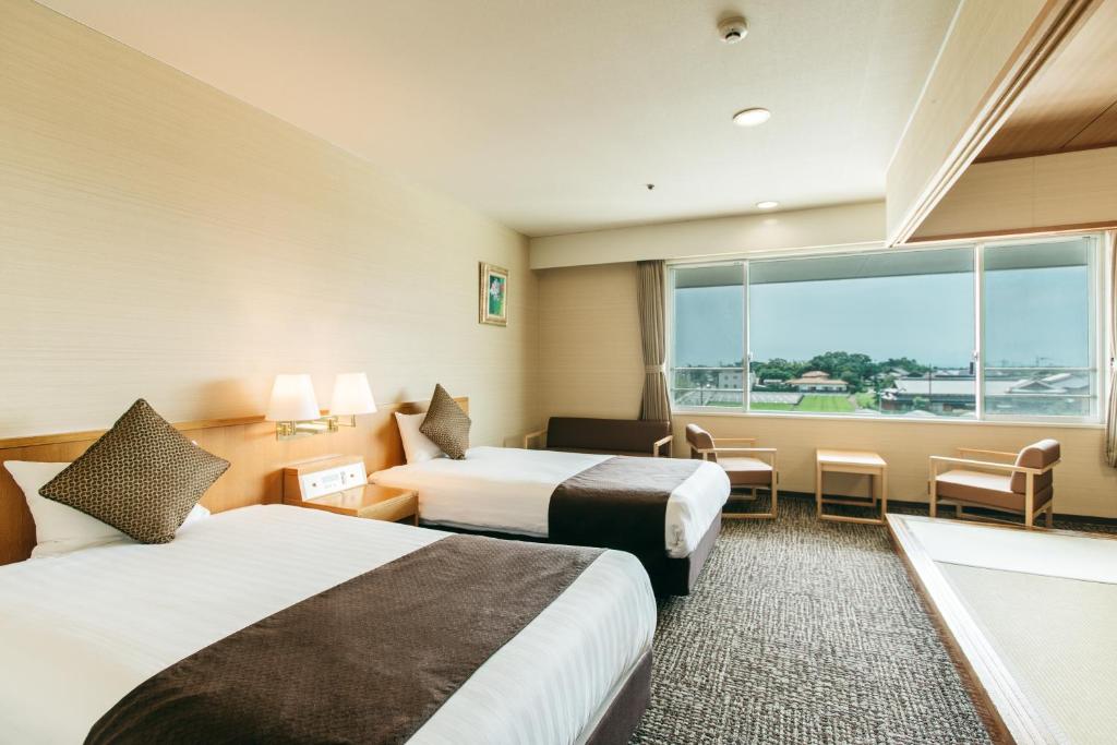 Postel nebo postele na pokoji v ubytování KAMENOI HOTEL Yanagawa