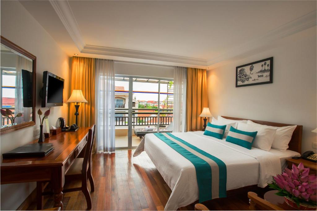 Postel nebo postele na pokoji v ubytování Hotel Somadevi Angkor Resort & Spa