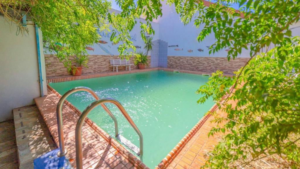 a swimming pool with a stairway leading into a house at Finca Real de Niebla by Ruralidays in Huelva