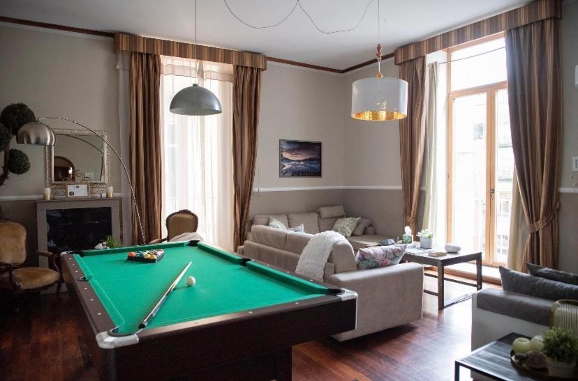 a living room with a pool table in it at Grandapartments via Duomo Napoli in Naples