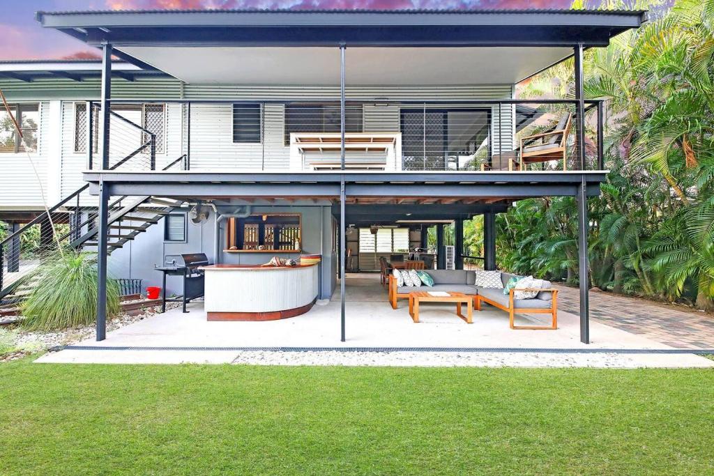 a house with a large open patio with a deck at A Tropical Pool Paradise in Rapid Creek in Nightcliff