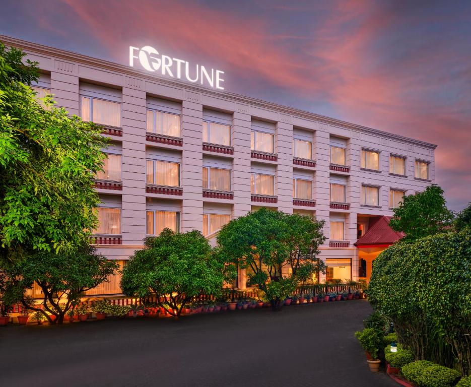 a white hotel with a sign on the side of it at Fortune Park, Katra - Member ITC's Hotel Group in Katra