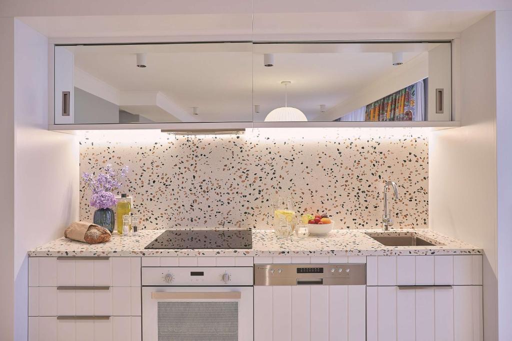 a kitchen with a sink and a counter top at Adina Apartment Hotel Chippendale in Sydney